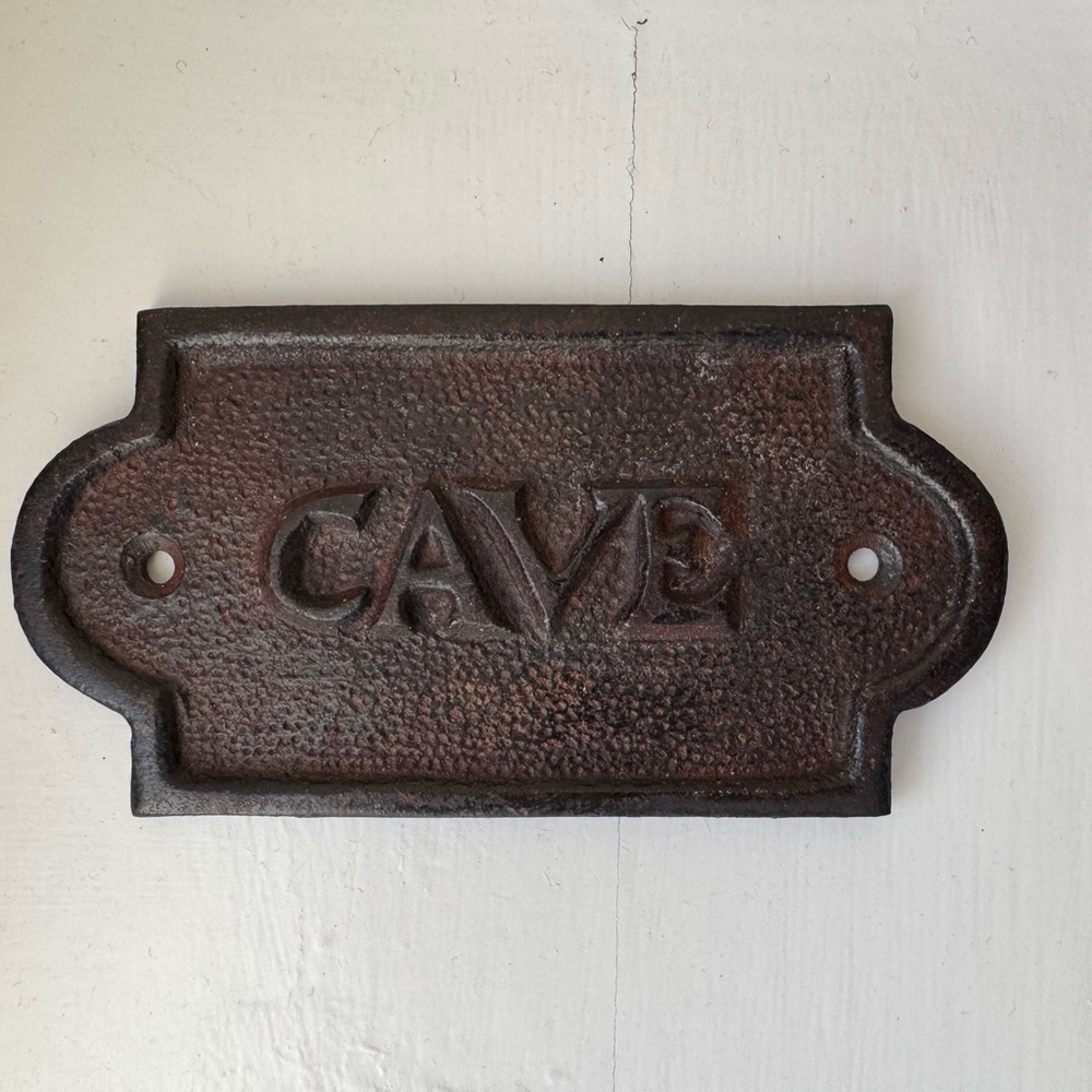 Vintage cast iron wine cellar sign